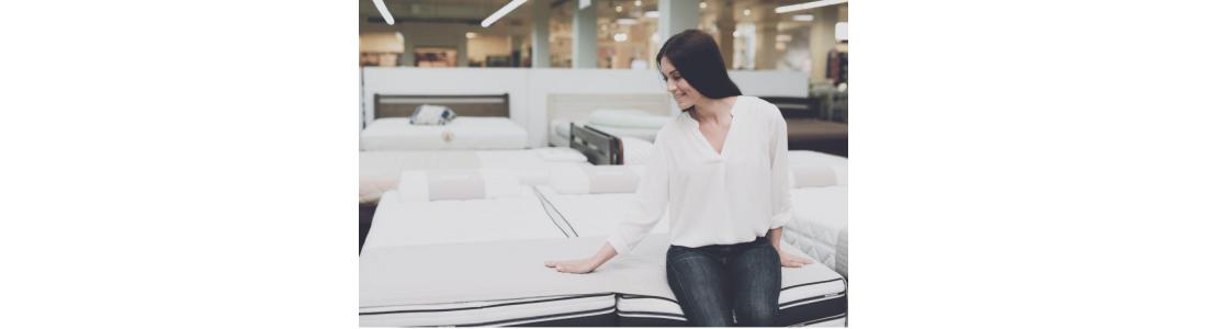 Women comparing brand name mattress and a no name mattress while shopping