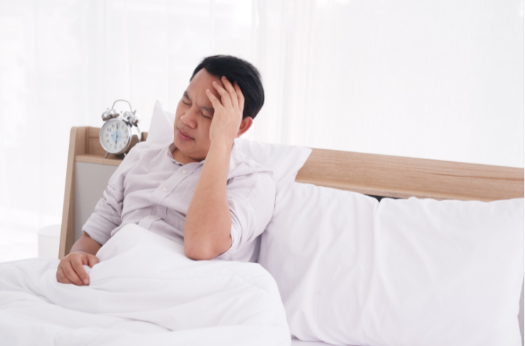 Man waking up cranky from lack of sleep